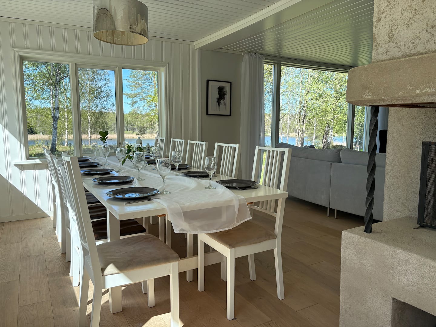 Long dining table set for a gathering, with views outside